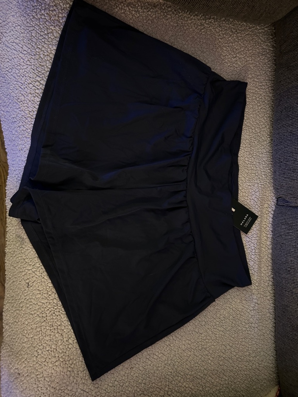 HALARA Blue Logo Tag on Dark Fabric